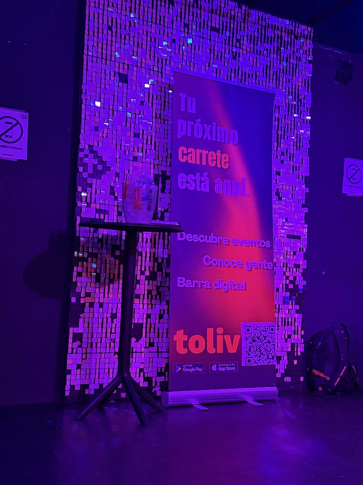 A Toliv banner with a QR code and a shot table, lit purple